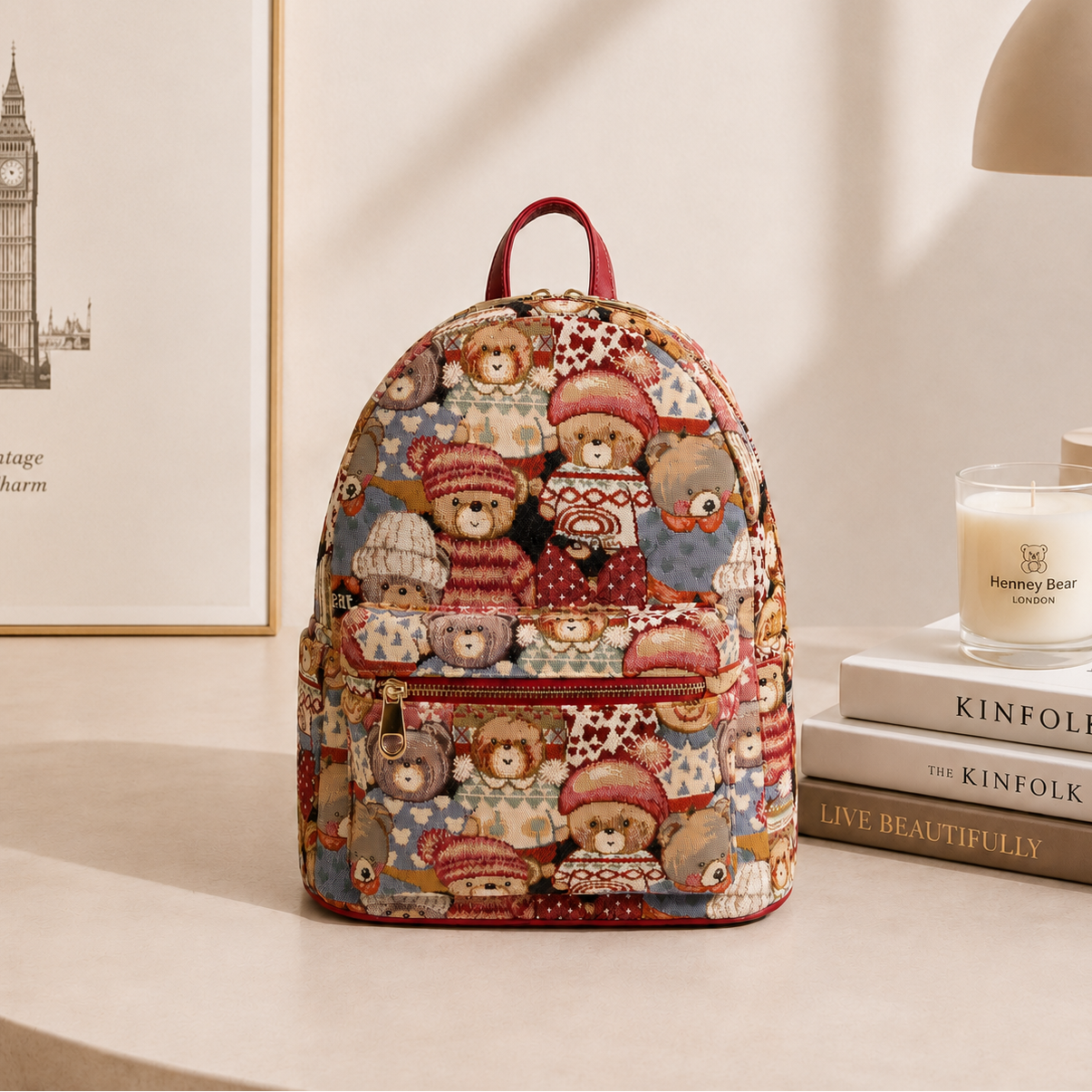 Backpack with teddy bear pattern on a surface with books and a candle